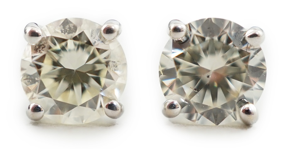 A pair of 18k white gold and solitaire diamond set ear studs